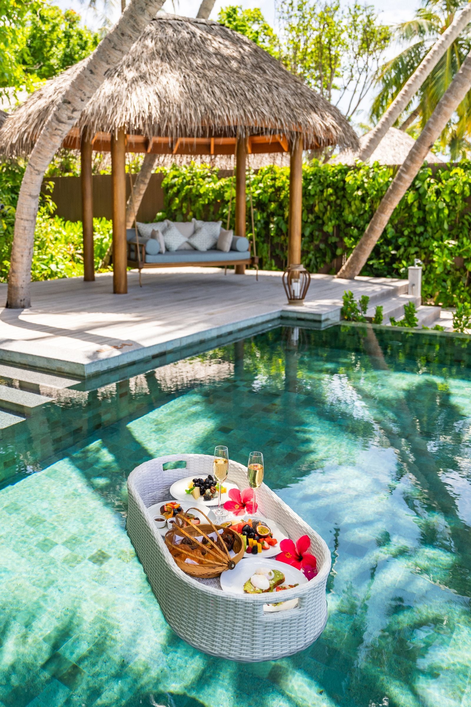 Breakfast floating in the private pool of the Baros Suite, with its thatched gazebo behind